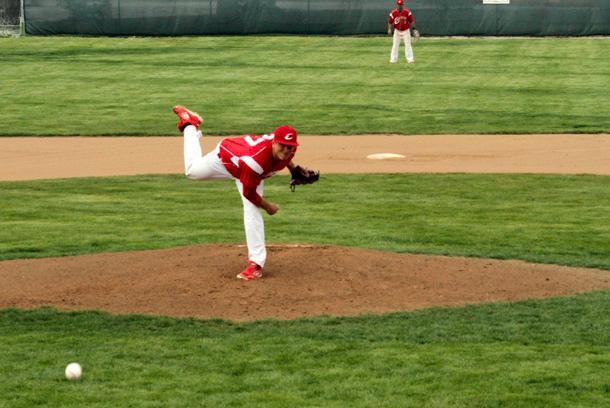 Jordan Basinger delivers a pitch against Lakeland in today's second game. The sophomore righty came within one out of a no-hitter. Below left is Nick Collins tagging a runner out on a failed steal in the sixth inning of the first game. Below right is Michael Louis lining a two-run single to left center in the fourth inning of the first game. Photos by Cherie Guthrie/Owens Sports Information