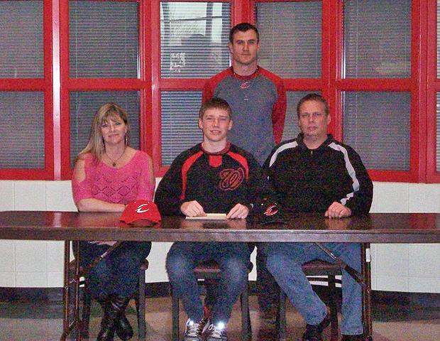 Tyler Byerly, front center, is joined by his parents and Express head baseball coach Devin Taylor as he signs his letter of intent to play for the Express next year. Photo by Amanda Flowers/Owens Sports Information