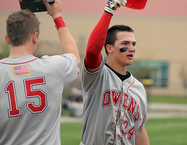 Charlie Sipe (right) is congratulated by Taran Temple (15) after Sipe's first homer of the day against Cuyahoga. Photo by Nicholas Huenefeld/Owens Sports Information