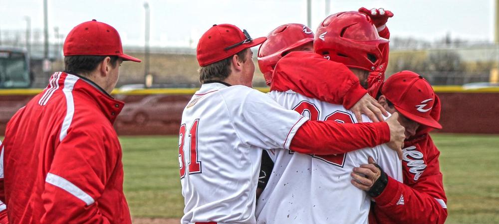 Ben Breymier is mobbed by his teammates after a walk-off RBI single in today's first game. Photo by Tobias Flemming/Owens Sports Information