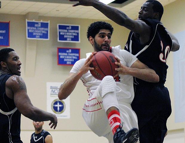 Bik Gill navigates traffic in the paint against Sinclair in tonight's district semifinal. The sophomore had 23 points, 18 rebounds and six blocks. Photo by Geoff Roberts/Owens Sports Information