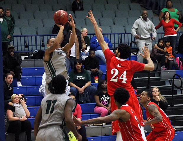 Winston Grays hits the game-winning jumper over Bikramjit Gill to win the district championship. Photo by Geoff Roberts/Owens Sports Information