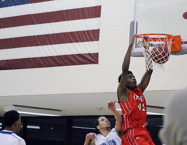 Kenny Jones throws down a two-handed dunk in the second half of today's 90-57 win over Kellogg Community College. The freshman had 17 points, 10 rebounds, four steals and two blocks. Photo by Nicholas Huenefeld/Owens Sports Information