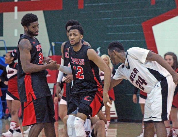 John Murry is helped up by Darren Groves after getting fouled in the second half. Murry finished with a game-high 27 points. Photo by Nicholas Huenefeld/Owens Sports Information