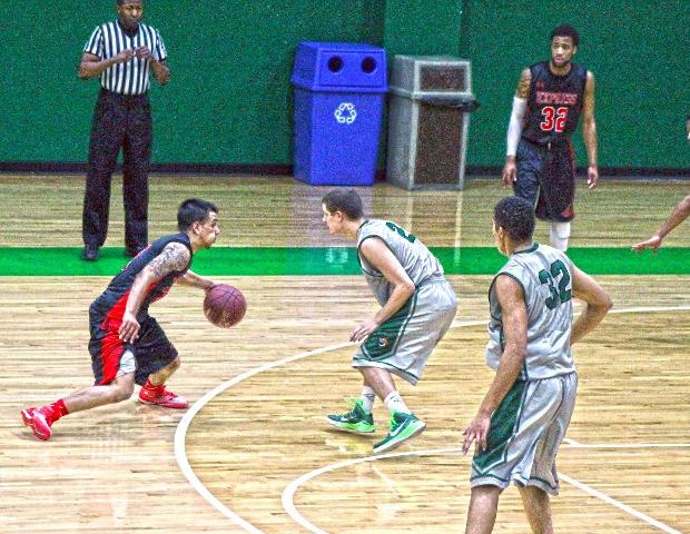 Cameron White looks to make a move against Cincinnati State's Cory Smith in today's 86-73 loss. Photo by Nicholas Huenefeld/Owens Sports Information