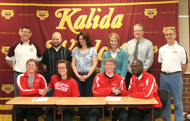 Express women's soccer head coach Mary Whisler, bottom left, shakes hands with Erika Brinkman, while Express men's soccer head coach Art Johnson, bottom right, shakes hands with Tyler Kortokrax. Both players signed to play soccer at Owens next season. Photo courtesy of Putnam County Sentinel Newspaper