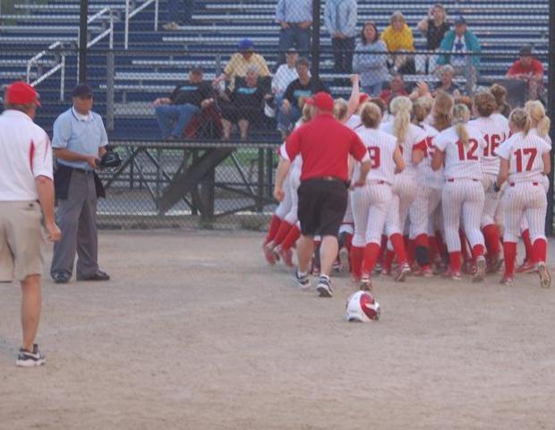 Allison Hausch is mobbed by her teammates after hitting a walk-off home run to send her team to the district championship game. Photo courtesy of Sharon Snyder
