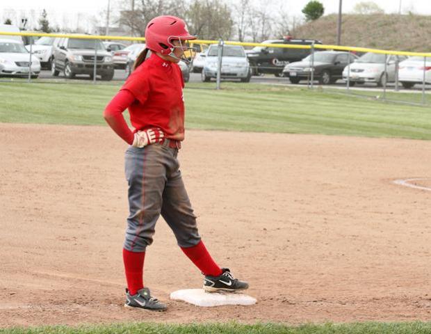 Melanie Iacoangeli waits for action while at third base. The freshman right fielder eclipsed the 60 steal mark this season with her 60th and 61st stolen bases against Macomb. Below, Kasey Graham delivers a pitch. Her win in game one improved her record to 11-1. Photos courtesy of Cherie Guthrie/Owens Sports Information