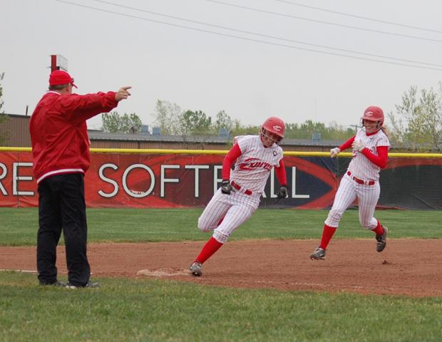 Amanda Sinay, far right, chases Michelle Hollister on Sinay's inside the park grand slam in the second game of today's doubleheader. Below right is April DeCant hitting her first home run of the season, while below left is Allison Hausch being congratulated by Express head coach Duane Lanham on her first homer of the season. DeCant and Hausch hit their homers back-to-back in the fifth inning of game two. Photos by Sharon Snyder/Owens Sports Information