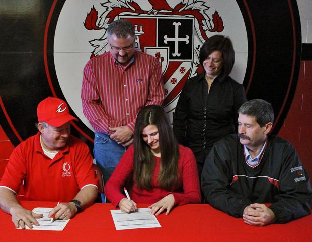 Alex Veres is joined by her parents in the back, as well as Express softball head coach and Cardinal Stritch head softball coach Don Zbierajewski as she signs her letter of intent to play for the Express next year. Photo by Nicholas Huenefeld/Owens Sports Information