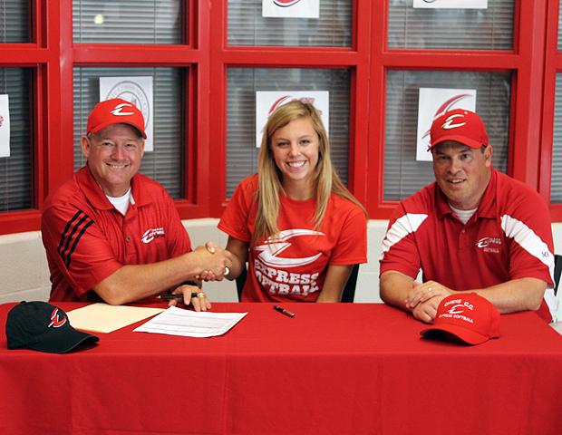 Emily Morrow shakes hands with Express softball head coach Duane Lanham after signing her letter of intent. Also pictured is Express softball assistant coach Kevin Snyder. Photo by Nicholas Huenefeld/Owens Sports Information