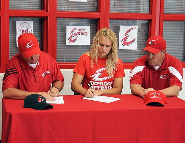 Haley Hudgin signs her letter of intent to play for the Express next year. Also pictured with her is Express softball head coach Duane Lanham and Express softball assistant coach Kevin Snyder (L to R). Photo by Nicholas Huenefeld/Owens Sports Information