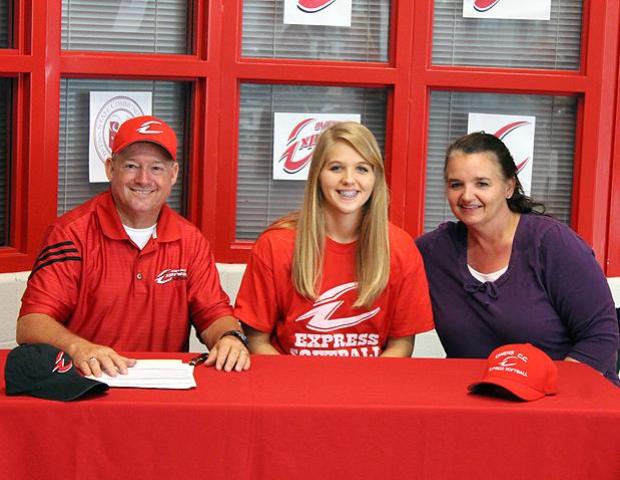 Josephine Hall (center) is joined by her mother, Diana, and Express softball head coach Duane Lanham after signing her letter of intent to play for the Express softball program next year. Photo by Nicholas Huenefeld/Owens Sports Information