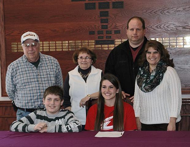 Sam Fowls, in red, is surrounded by her family after signing her letter of intent to play softball for the Express next year. Photo by Owens Sports Information