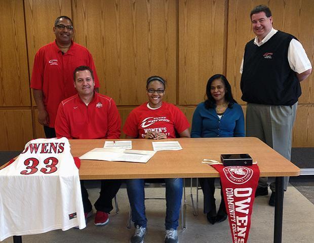 Ashley Tunstall, center, poses after signing her letter of intent to play for the Express women's basketball program next year. She is surrounded by Huber Heights Wayne head girls basketball coach Geoff Springer and Express women's basketball head coach Mike Llanas to her right, as well as her mother, Stephanie, and Express women's basketball assistant coach Stephen Perry to her left. Photo by Owens Sports Information