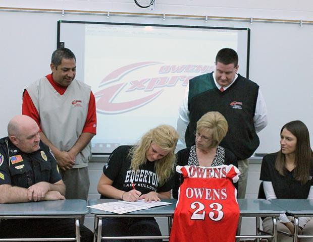 Hannah Griffin, front center, signs her letter of intent during a ceremony at Edgerton High School Monday. She is surrounded by her parents, Dan and Jana Griffin, as well as her high school coach, Kelly Thiel (far right). In the back is Express women's basketball head coach Mike Llanas and assistant coach Stephen Perry (L to R). Griffin is the first member of next year's freshmen class. Photo by Nicholas Huenefeld/Owens Sports Information