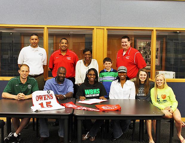 Kheri Motley (front middle) is joined by Express women's basketball coaches Mike Llanas and Stephen Perry, as well as her friends and family during her signing ceremony. Photo by Nicholas Huenefeld/Owens Sports Information