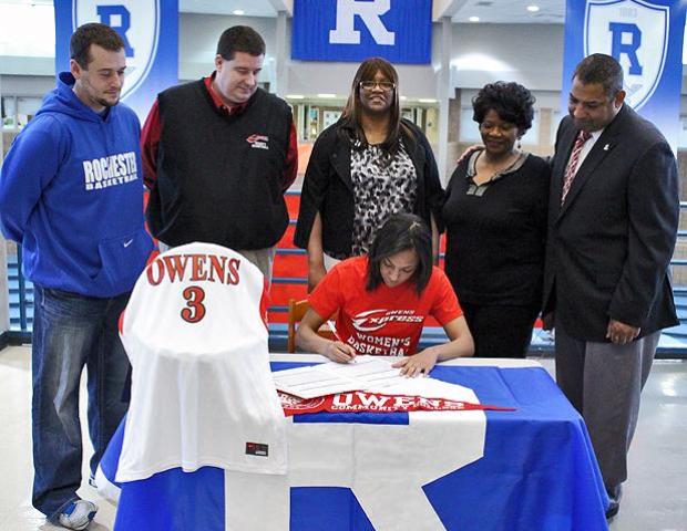 Zhana Randolph signs her letter of intent as she is surrounded by Express head coach Mike Llanas, Express assistant coach Stephen Perry, Rochester head coach Adam Sheldon, her mother Angela and her grandmother. Photo by Nicholas Huenefeld/Owens Sports Information