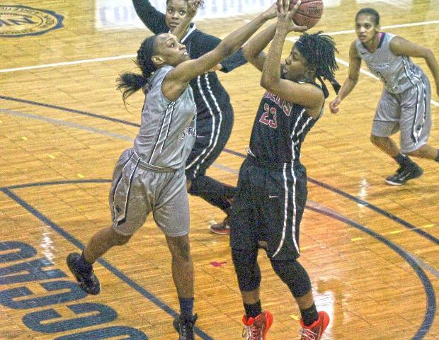Sierra Harley, pictured here shooting over Columbus State's Erinn Bailey, had 25 points, nine rebounds and nine assists in today's 69-66 win over Columbus State. Photo by Tobias Flemming/Owens Sports Information