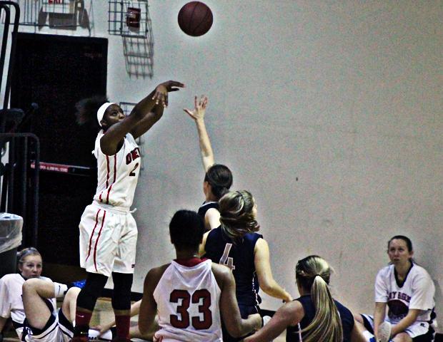 Tatyana Reynolds attempts a 3-pointer from the corner in today's 91-61 win over Olney Central/ The freshman scored a game-high 18 points. Photo by Nicholas Huenefeld/Owens Sports Information