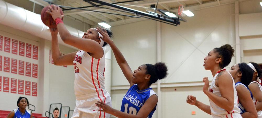 Aysah Ingram towers over a Lakeland defender for a layup. Photo by Amanda Aylwin/Owens Sports Information