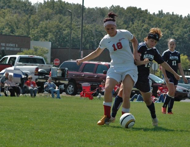 Drew Plummer battles a Kellogg defender for possession. The sophomore tallied three assists today, which tied the single game record. Photo by Nicholas Huenefeld/Owens Sports Information