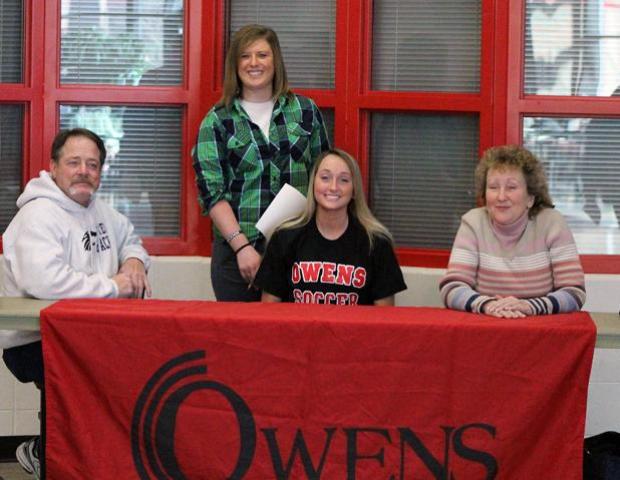Brittany Powell, front center, became the fourth member of the 2013-14 freshmen class today. She is surrounded by her parents, Brent and Robene Powell, and Express women's soccer head coach Mary Whisler. Photo by Amanda Flowers/Owens Sports Information