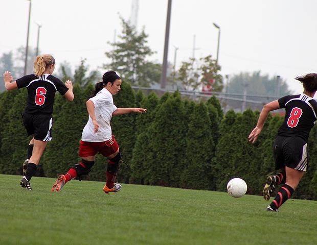 Jessica Grindle breaks free past two Lake Michigan defenders in the second half of today's 3-0 win over Lake Michigan College. Photo by Nicholas Huenefeld/Owens Sports Information