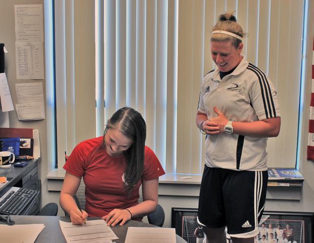 Kayla Lehmann signs her letter of intent as Express women's soccer head coach Mary Whisler looks on. Photo by Nicholas Huenefeld/Owens Sports Information