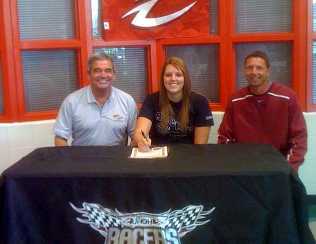Brittany Egbert, center, signs with UNOH as her former coach, Sonny Lewis, is to her right and her future coach, Kevin Kitchen, is to her left. Photo courtesy of Owens Sports Information