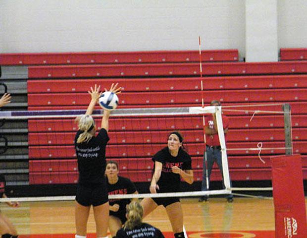 Alyssa Meis smashes a ball past a Macomb CC player in a recent scrimmage in the SHAC. Photo courtesy of Nicholas Huenefeld/Owens Sports Information